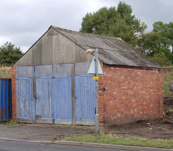 View of a blue door old garage situated on Twyford Road at Willington.