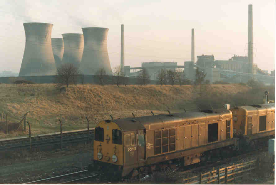 Class 20 No. 20 112 and unidentified class mate pass under Buckfoird Lane Bridge at Findern with Willington Power Station in the backgrouund.